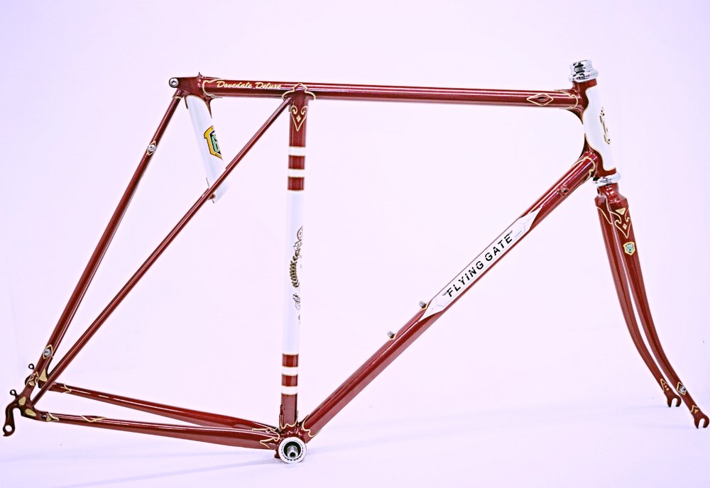 Handbuilt in Reynolds 631 - Dovedale Deluxe featuring concealed brake and gear cable routing. Flam ruby with pearl white panels and gold luglining.&nbsp;Photos  Jonny Keeley .